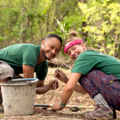 A Projects Abroad staff member and a student plant trees as part of their conservation volunteer work in Costa Rica. A volunteer and staff member work together on a reforestation initiative during Conservation volunteering in Costa Rica.
